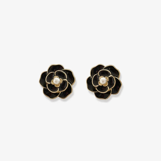 Elegant black enamel screw back clip on earrings for women, featuring a pearl center and flower design.