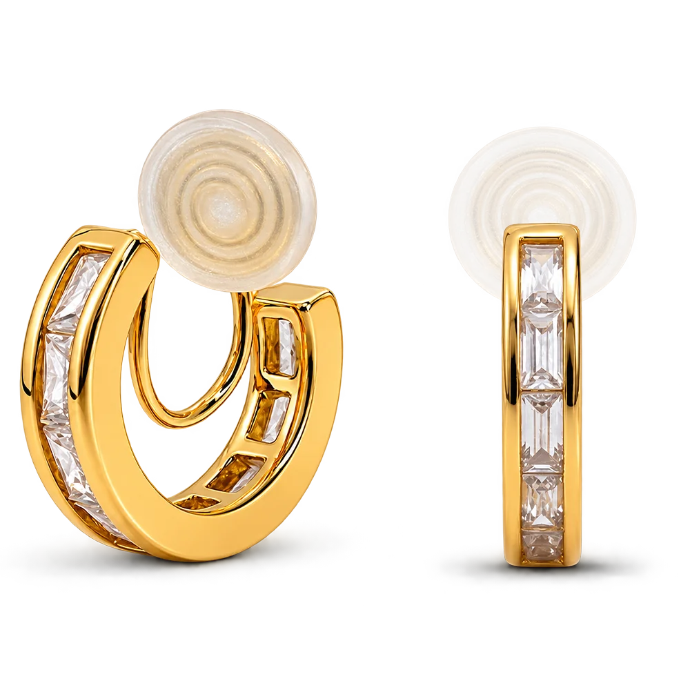 A pair of gold huggie hoop earrings with baguette-cut clear stones, shown from the front and side on a white background.