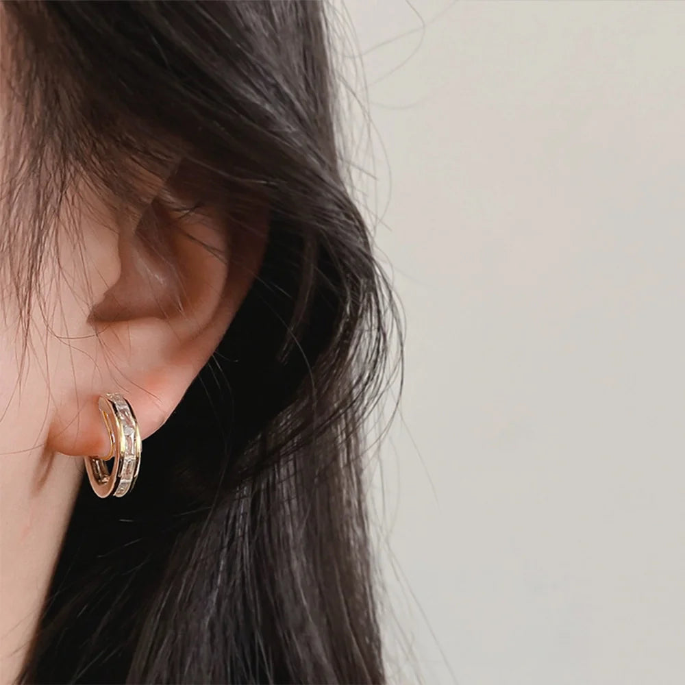 Channel-Set Zirconia Clip-On Hoop Earrings gold side view on ear with dark hair