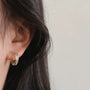 Channel-Set Zirconia Clip-On Hoop Earrings gold side view on ear with dark hair