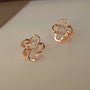 Rose gold cherry blossom floral ear cuffs displayed at angle on white background showing detailed design