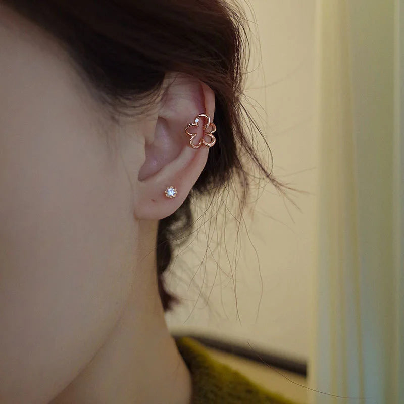 Cherry blossom floral ear cuffs in rose gold worn on ear, side view showcase delicate flower design