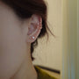 Cherry blossom floral ear cuffs in rose gold worn on ear, side view showcase delicate flower design
