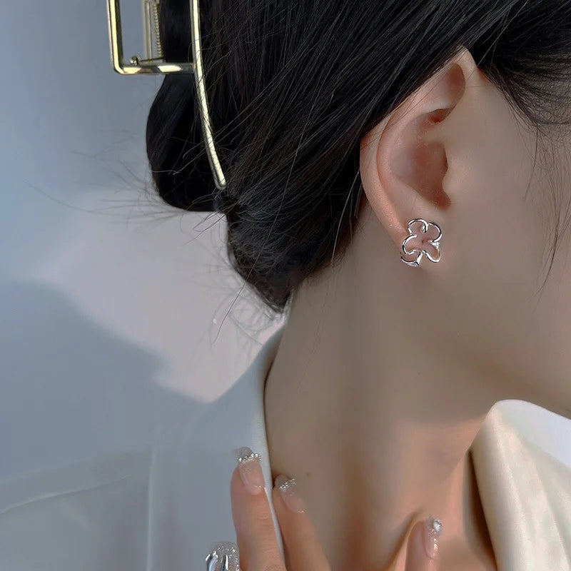 Cherry Blossom Floral Ear Cuffs in white gold, side view worn on ear with black hair and light background