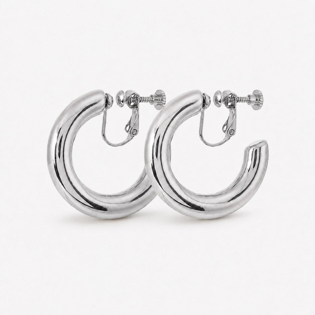 Silver classic hoop clip on earrings front view on white background showing polished metal finish and screw back closure