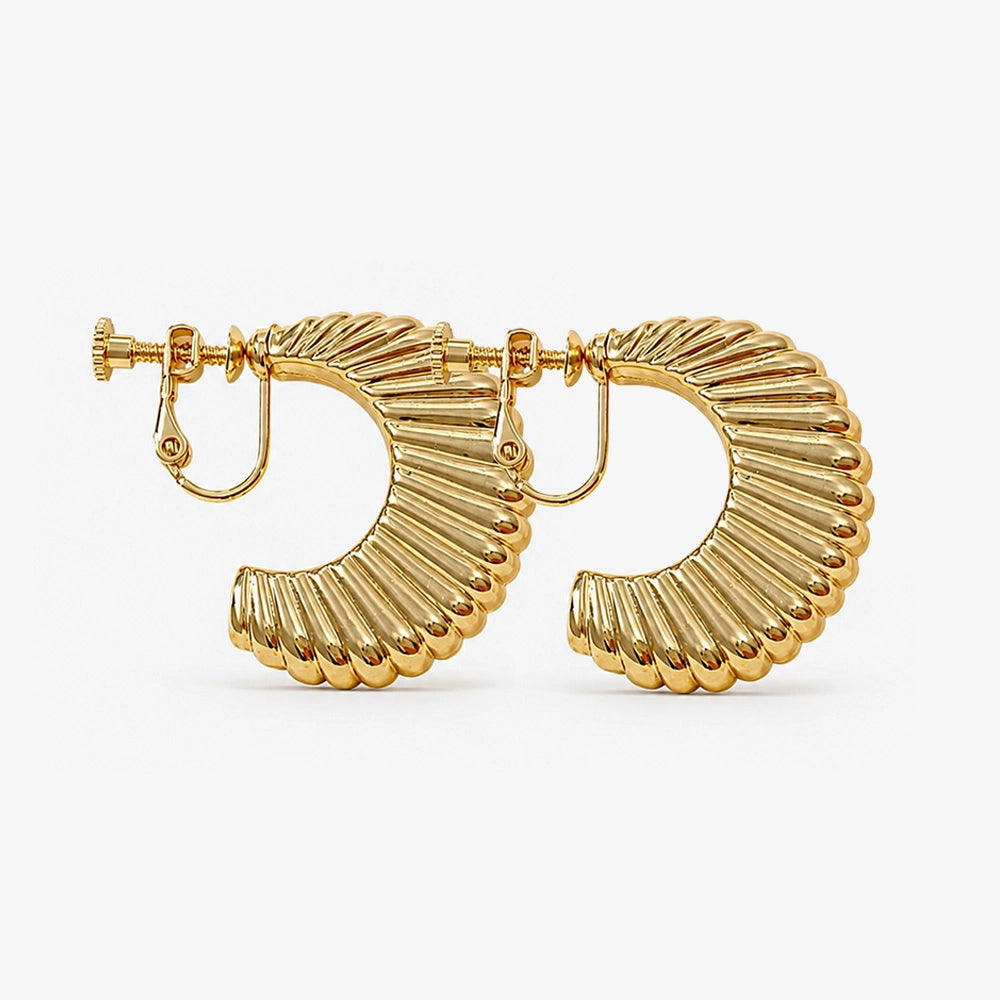 Gold hoop earrings with a textured design on a white background