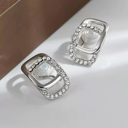 Close-up of the front and back of Crystal Frame Clip-On Earrings emphasizing their white gold finish.