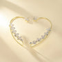 Crystal Leaf Cuff Earrings in Gold displayed at an angle on a cream background showing the sparkling cubic zirconia leaf design