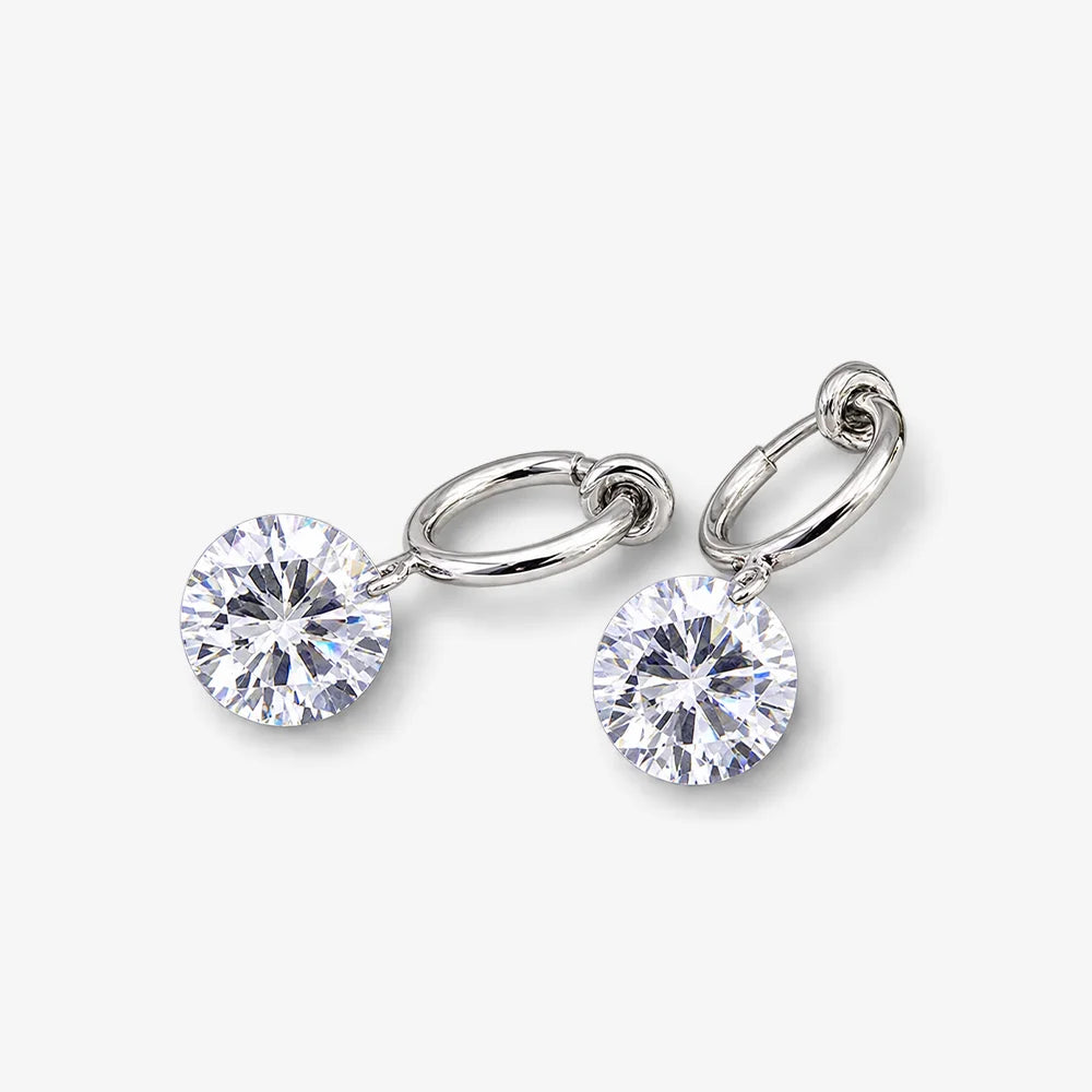 Diamond charm hoop clip-on earrings with round crystal stones on silver tone metal, shown on a light gray background.