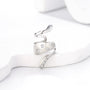 Silver snake ear cuff with zirconia accents displayed on white hand model, showing detailed side view of polished metal design