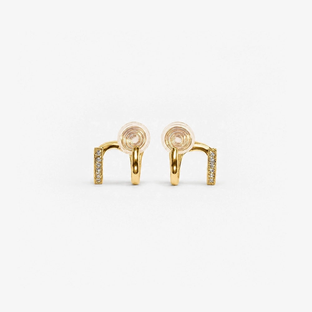 Elegant gold-toned double hoop clip-on earrings, adorned with sparkling zircon accents, feature a unique two-tone design. 