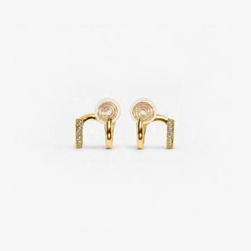 Elegant gold-toned double hoop clip-on earrings, adorned with sparkling zircon accents, feature a unique two-tone design. 