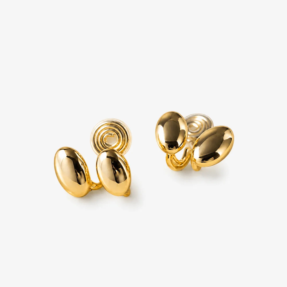 A pair of gold oval stud earrings with a polished finish, displayed on a clean off-white background.