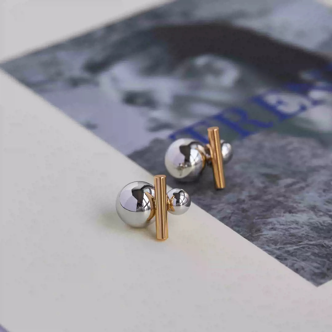 Side angle of Dual-Tone Sphere and Bar Clip-On Earrings highlighting the dual-tone gold and silver plating.