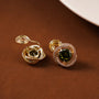 Elegant large emerald zirconia clip-on earrings in gold tone, displayed on brown background showing detailed front view