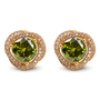A pair of gold stud earrings featuring a large round green center stone surrounded by a halo of small clear stones, set against a plain white background.