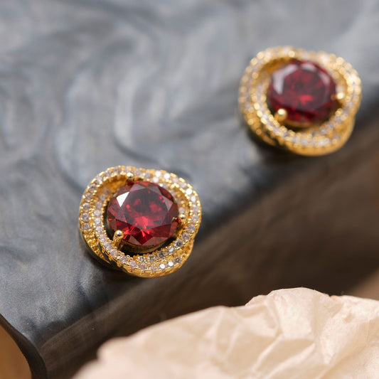 Elegant clip-on earrings featuring a deep red ruby zircon and white zircon stones.