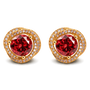 A pair of gold stud earrings featuring a large round red gemstone in the center, surrounded by a halo of small clear stones, on a plain white background.