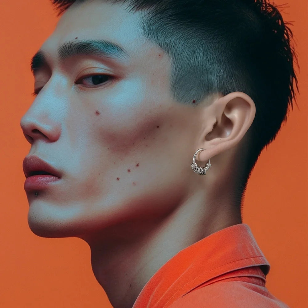 Silver Embrace clip-on hoop earrings side profile view on orange background, worn by model