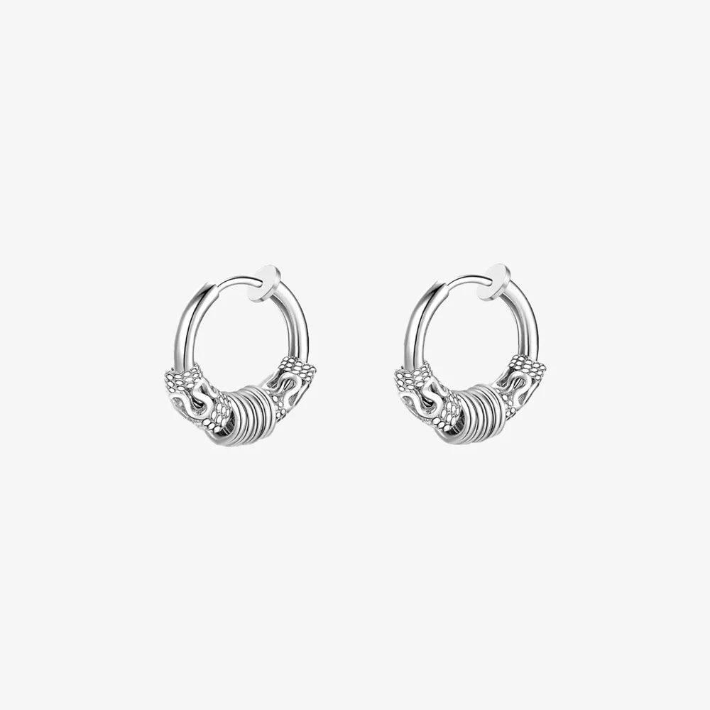 Pair of Embrace Clip-On Hoop Earrings in Silver displaying the detailed pattern.