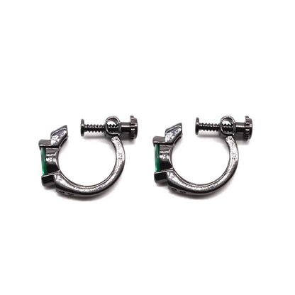 Side view of black hoop earrings featuring an emerald zircon.