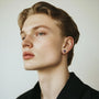 Model wearing emerald dragon claw magnetic stud earrings, showcasing bold and secure fit