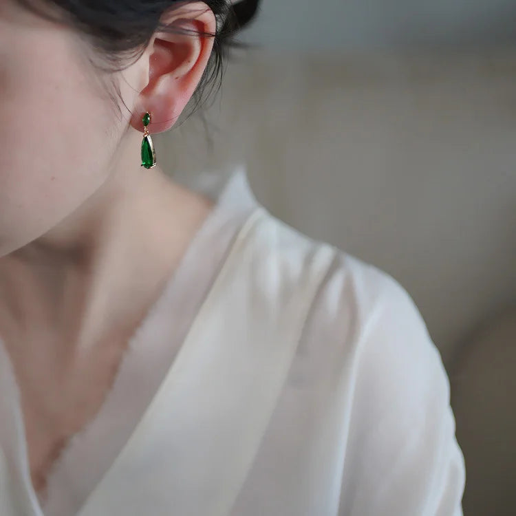 Woman wearing Emerald Teardrop Clip-On Earrings