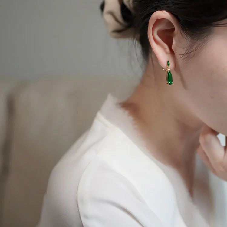 Side view of Emerald Gold Clip-On Earrings on a model