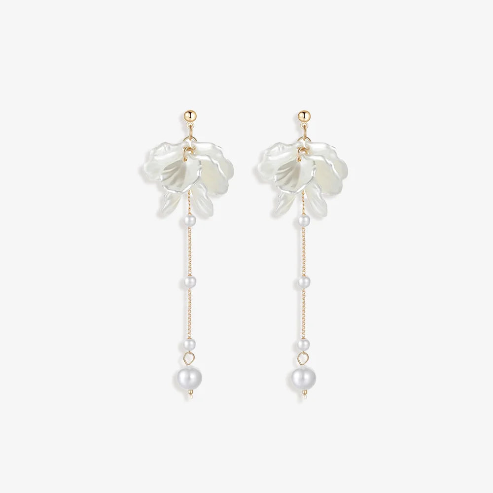 Pair of Floral Pearl Clip Earrings displayed on a soft white surface, capturing the intricate design and luxurious materials.