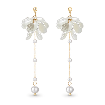 A pair of long dangle earrings featuring white flower-shaped charms, gold posts, and white pearl beads hanging from delicate gold chains