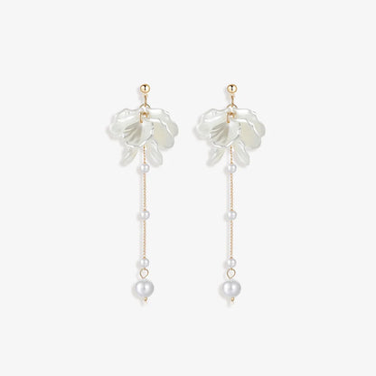 Pair of Floral Pearl Screw Back Earrings displayed on a soft white surface, capturing the intricate design and luxurious materials.