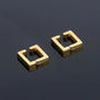 Gold geometric square clip-on earrings displayed at angle on gray background, showing polished finish and hollow square design