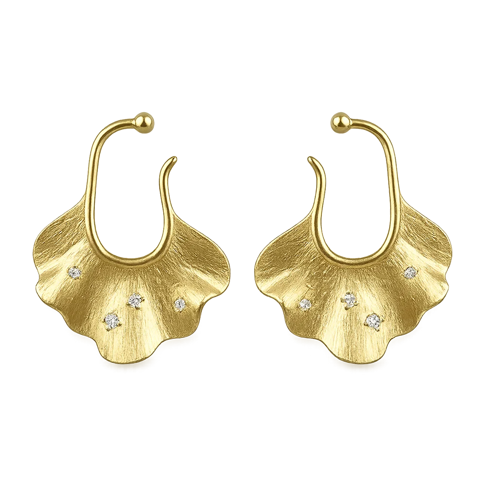 Gold Ginkgo Leaf Ear Cuff Earrings set on a white surface, featuring sparkling white zircon inlays that capture the light, reflecting the organic beauty and luxury of the conch cuff earrings.
