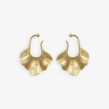 Gold Ginkgo Leaf Ear Cuff Earrings set on a white surface, featuring sparkling white zircon inlays that capture the light, reflecting the organic beauty and luxury of the conch cuff earrings.