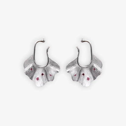 Pair of silver Ginkgo Leaf Ear Conch Cuff Earrings with cherry red zircon accents displayed on a white background, symbolizing nature's eternal elegance and perfect for adding a botanical touch to any outfit.