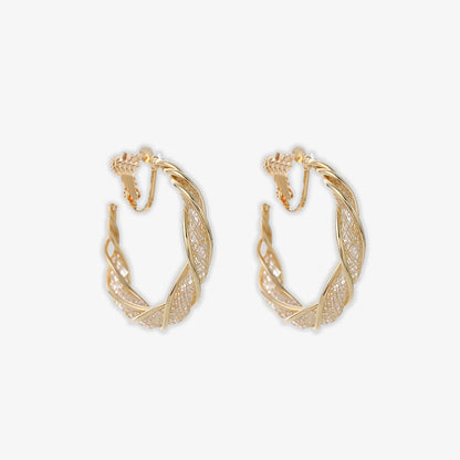 Discover the ultimate in elegance with our Glimmering Lattice Twist Clip-On Earrings in Gold. Perfect for those who love the luxurious look of gold without the need for pierced ears.