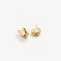 Glossy gold clip-on hoop earrings displayed on white surface, showcasing polished finish and curved design from angled view