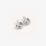 Glossy silver clip-on hoop earrings displayed at an angle on white background showing polished metallic finish and curved design