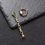 Gold chain magnetic hoop earrings displayed on slate with matching chain bracelet, front view showing gold-tone metal design
