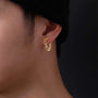 Gold chain magnetic hoop earrings side view worn on ear, textured link design in warm gold tone