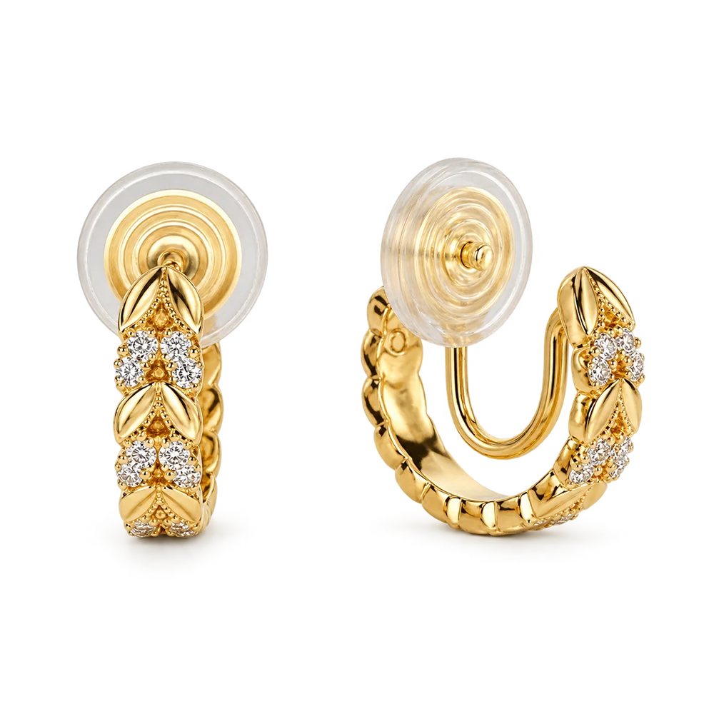 A pair of gold huggie hoop earrings with clear pavé diamond leaf motifs, shown from both front and side angles on a white background.