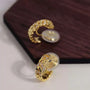 Gold chain zirconia clip-on hoop earrings displayed on burgundy box, showing detailed front angle view with cubic zirconia stones