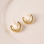 Gold chain zirconia clip-on hoop earrings displayed at an angle on a white background