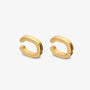 A pair of polished gold huggie hoop earrings on a clean, light gray background.