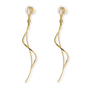 A pair of gold dangle earrings with a twisted, flowing wire design and clear crystal backings, shown on a solid white background.