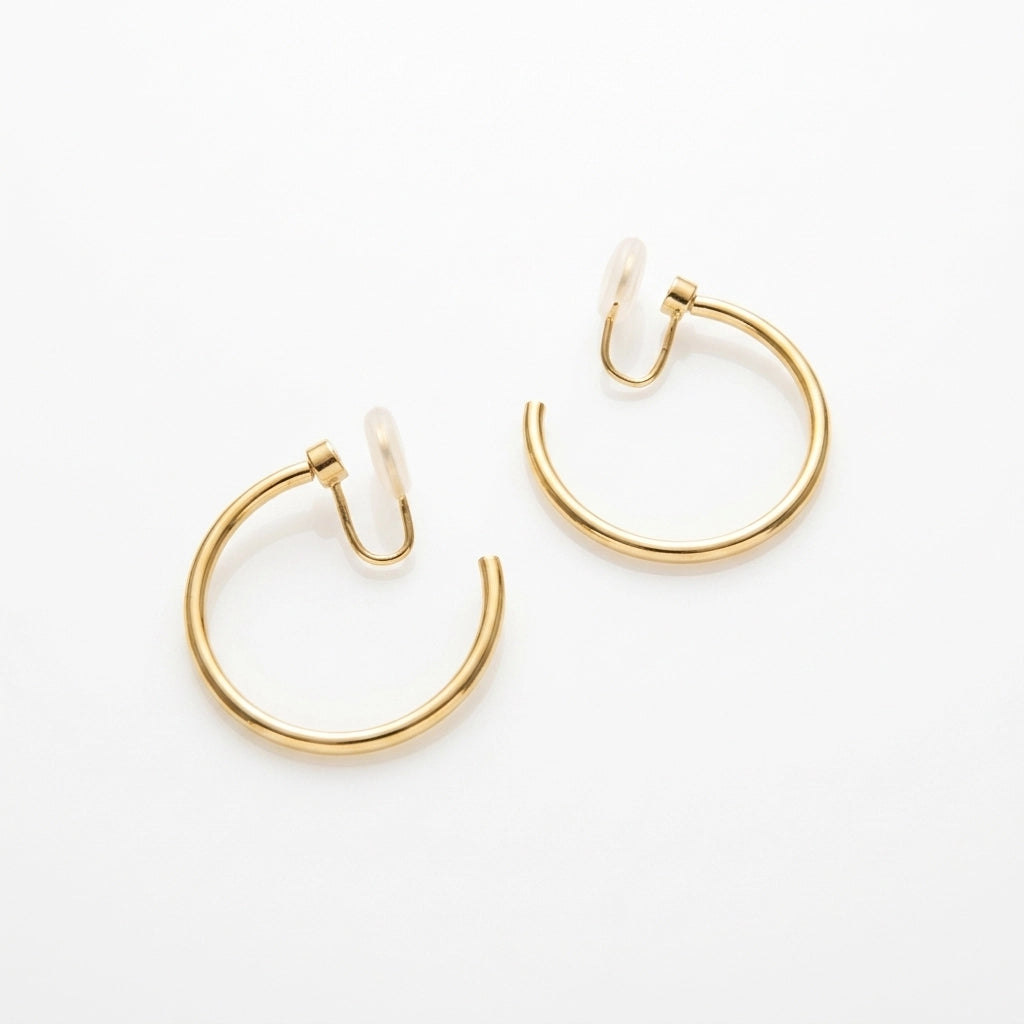 A pair of rotating yellow gold hoop earrings with u-type closures, shown on a clean white background.