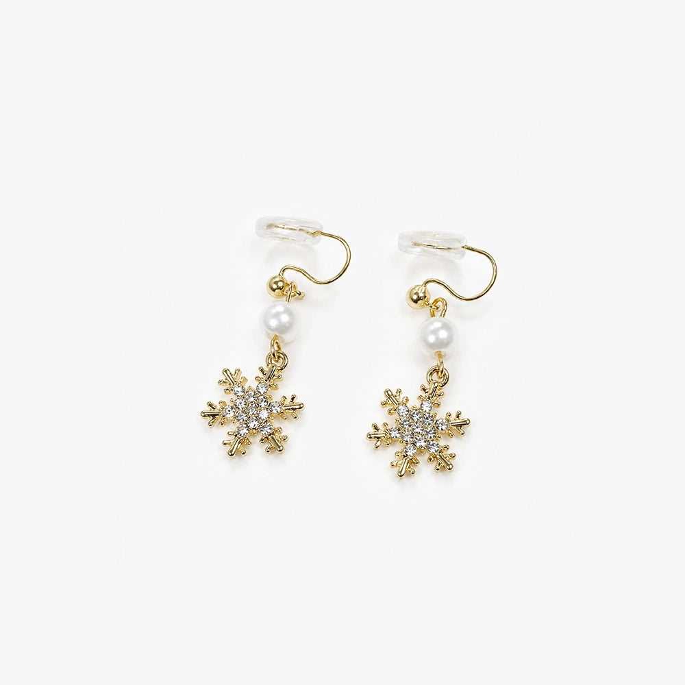 Gold snowflake zirconia clip-on earrings with pearl accents, front view on white background