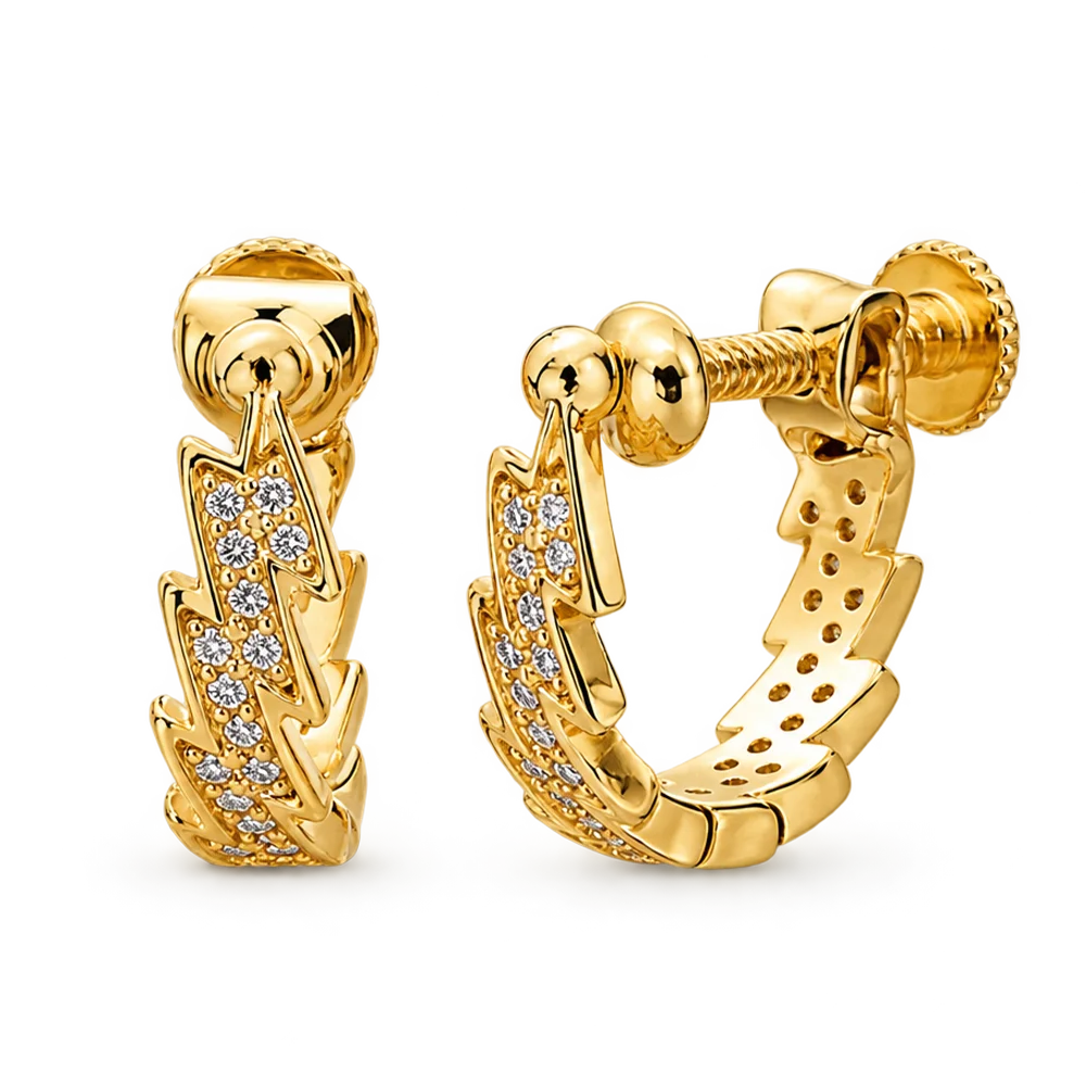 A pair of gold huggie hoop earrings with a textured, layered chevron design paved with small clear cubic zirconia stones, shown on a solid white background.
