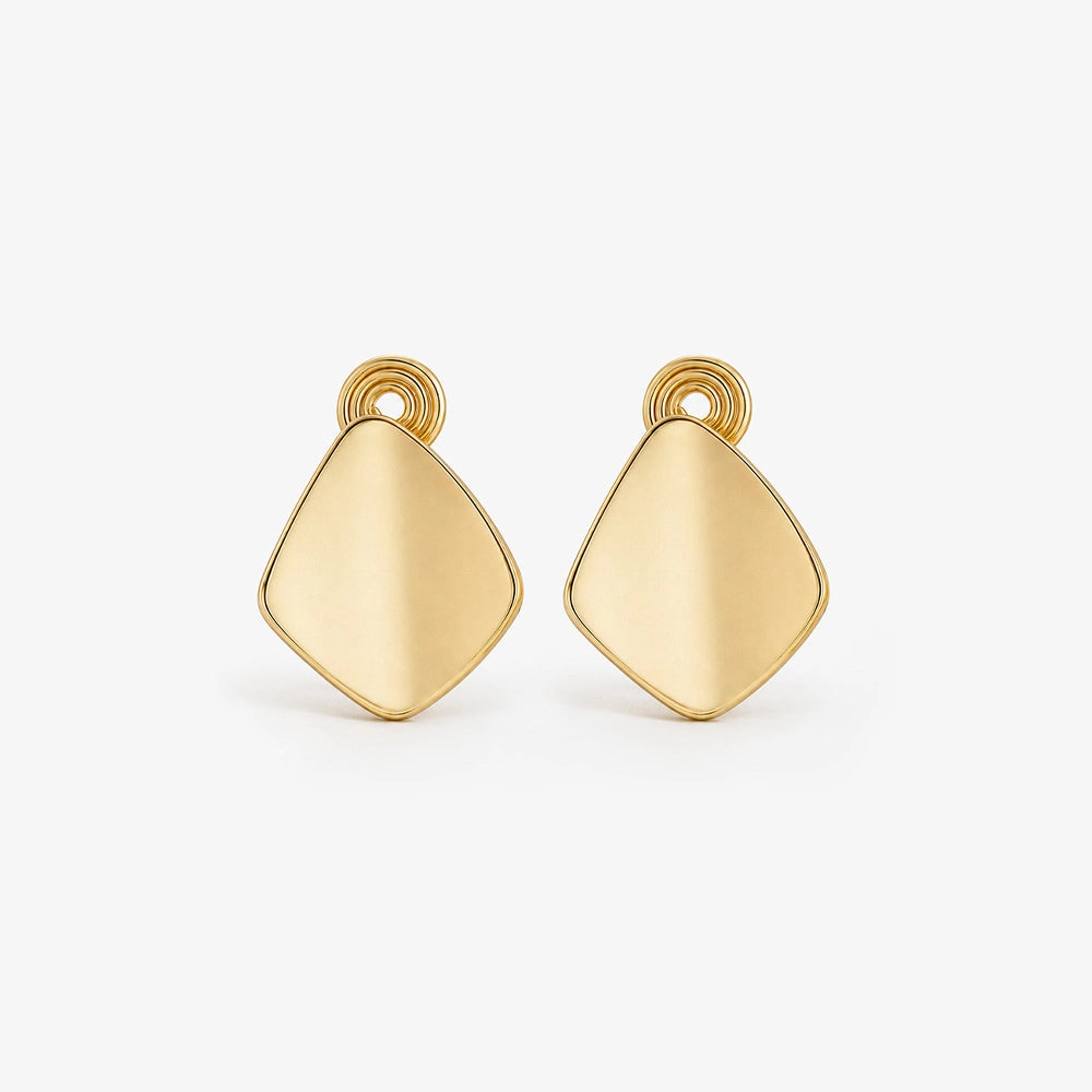 Chunky gold square clip-on stud earrings make a statement with their geometric design. 
