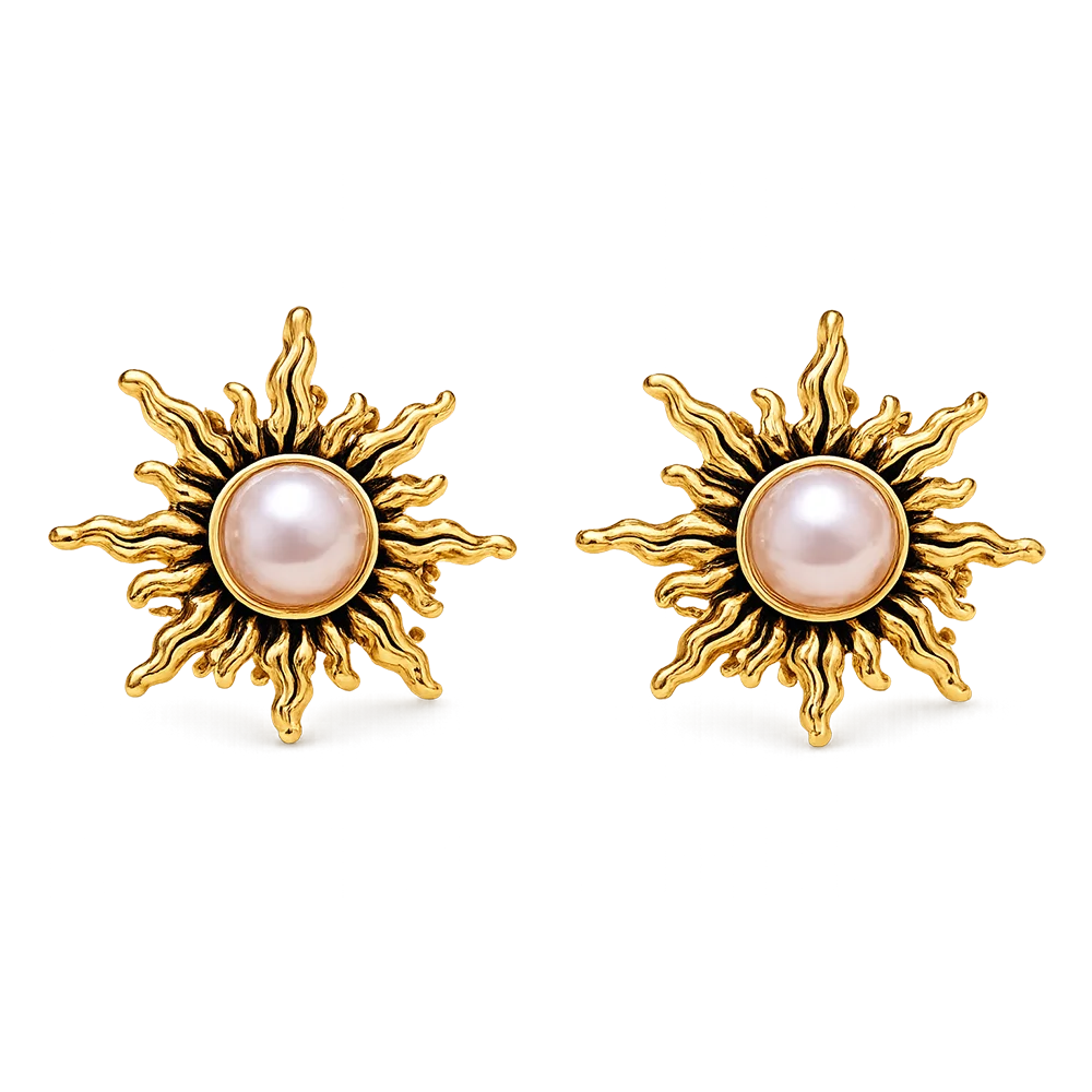 A pair of gold sunburst stud earrings with a round pale pink pearl in the center, set against a plain white background.